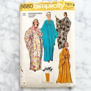 May include: Vintage Simplicity sewing pattern 5680 featuring illustrations of flowing dresses and robes. The pattern includes the text "Proportioned to Your Height" and "Jiffy easy cut-easy sew". The pattern is one size.