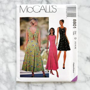 McCalls 8801. Sizes 4-8. 8-10, 18-22. princess seam midi dress. sleeveless open back bow tie detail. 1990s vintage sewing pattern