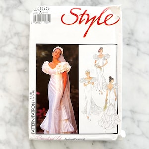 May include: A vintage sewing pattern for wedding dresses. The package features a photo of a bride in a white gown with a veil and illustrations of different dress styles. The word "Style" is written in red script.