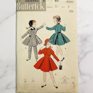 May include: Vintage sewing pattern for a girl's dress and pants. The pattern is from Butterick and is number 8350. The pattern is for size 4 and has a bust measurement of 23 inches. The pattern is for a dress with a cape and a pair of pants with suspenders.