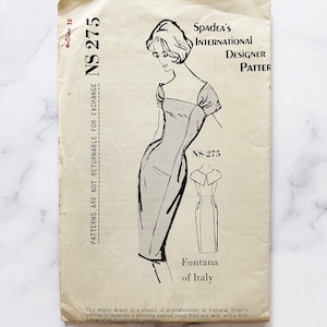 May include: Vintage sewing pattern for a sheath dress by Fontana of Italy. The pattern is labeled NS-275 and is from Spades International Designer Patterns.