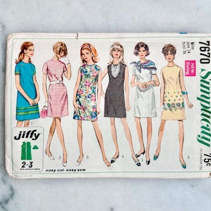 May include: A vintage Simplicity 7670 sewing pattern envelope for a miss size 14 dress. The front features illustrations of six different sleeveless dress styles in various colors and patterns, including floral, solid, and textured designs.