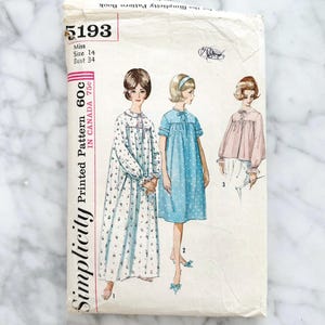 May include: Vintage Simplicity sewing pattern number 5193 for a nightgown or dress. The pattern includes three different styles, one with a floral print, one with a blue print, and one with a pink print. The pattern is for a size 14 with a bust size of 34 inches.