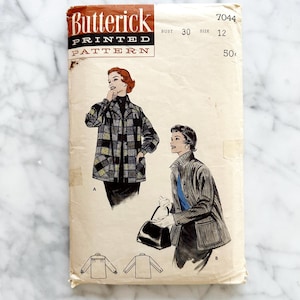 May include: Vintage Butterick printed pattern envelope. The envelope features illustrations of two women wearing coats. The text on the envelope reads "Butterick PRINTED PATTERN" and includes the bust size 30 and size 12.