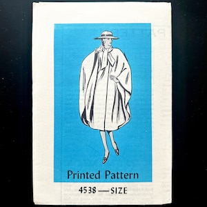 May include: A vintage sewing pattern for a white cape with a black illustration of a woman wearing the cape and a hat. The pattern number is 4538 and the text "Printed Pattern" is printed below the illustration.
