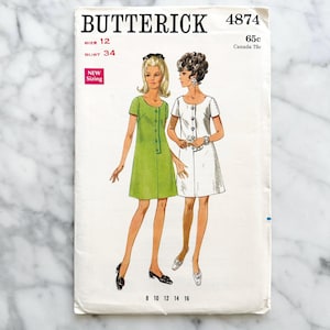May include: Vintage sewing pattern envelope for a dress, Butterick pattern number 4874, size 12, bust 34, with two models wearing the dress in green and white.