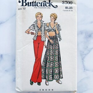 May include: Vintage sewing pattern envelope for a women's top and skirt. The pattern is from Butterick, pattern number 3700, size 10. The pattern features a red top with a white and green print and a green skirt with a geometric pattern. The pattern is priced at $1.25.