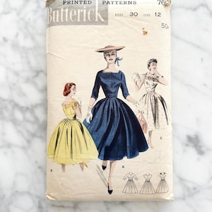 Puede incluir: Sobre de patrón de costura vintage para un vestido, con tres mujeres que llevan diferentes estilos de vestidos. El patrón es de Butterick, talla 12, pecho 30, y cuesta 50 centavos.
