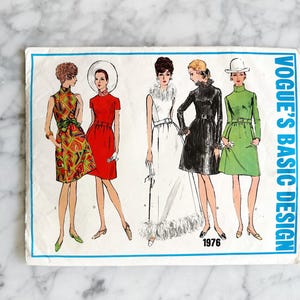 May include: A vintage sewing pattern booklet featuring four different dress designs. The cover features the text "Vogue's Basic Design" and the year "1976". The dresses are in various colors and styles, including a green dress, a red dress, a white dress, and a patterned dress.