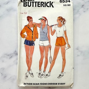 May include: Vintage sewing pattern for women's athletic wear. The pattern is for a jacket, tank top, and shorts. The pattern is by Butterick and is number 6534. The pattern is for size 12.