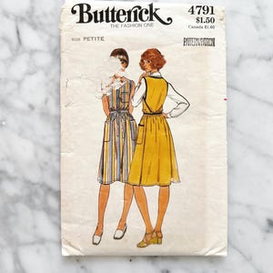 May include: Vintage sewing pattern for a dress, Butterick pattern number 4791, size petite, $1.50. The pattern shows two women wearing a yellow and a striped dress.