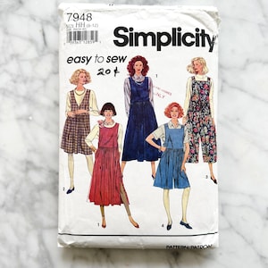 May include: Simplicity sewing pattern number 7948 for sizes 6-12. The pattern includes instructions for making five different styles of dresses with a jumper style. The pattern is for easy sewing and is labeled "204".