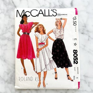 May include: A vintage McCall's sewing pattern featuring illustrations of three women's dresses. The pattern packet has the text "McCall's" and "Roland Klein" printed on it. The price is $3.50. The bust size is 30 1/2 inches.
