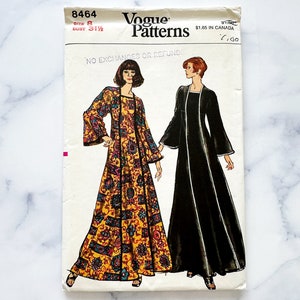 May include: Vogue Patterns sewing pattern number 8464 for a maxi dress with long sleeves. The pattern shows two versions of the dress, one in a black fabric and one in a yellow and black floral print. The pattern is for size 8 with a bust measurement of 31 1/2 inches. The pattern includes the text "No Exchanges or Refunds" and "$1.65 in Canada".