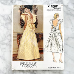 May include: A vintage Vogue Patterns sewing pattern featuring a design by Belville Sassoon. The pattern cover displays a yellow gown with a large bow detail. The text "Designer Original" and pattern number 1355 are visible.