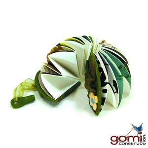 May include: A green and white paper accordion book with a flower design. The book is open and folded in a way that resembles a fan.