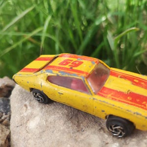 Rare Vintage GTO-Style Die-Cast Car – Racing Yellow Classic – Collector’s Treasure| Racing Number 69