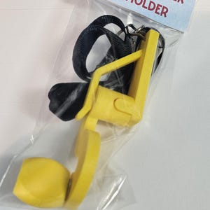 May include: A yellow tip-up winder and holder, packaged in a clear plastic bag. The winder has a black lanyard and the text "TIP-UP WINDER & HOLDER" on a light blue label.