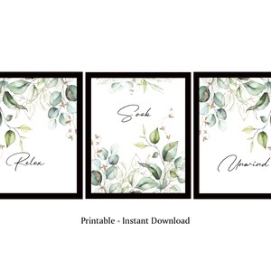 May include: Three printable wall art prints with a watercolor design of green leaves and gold accents. The prints feature the words "Relax", "Soak", and "Unwind".