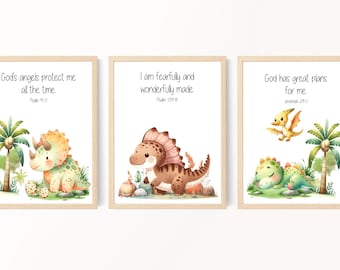 May include: Three printable wall art prints featuring cute dinosaur illustrations and inspirational bible verses. The first print features a green and orange triceratops with the verse "God's angels protect me all the time. Psalm 91:11". The second print features a brown dinosaur with the verse "I am fearfully and wonderfully made. Psalm 139:14". The third print features a green dinosaur with the verse "God has great plans for me. Jeremiah 29:11".
