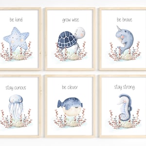 May include: Six framed watercolor prints with sea creatures and inspirational phrases. Each print features a different sea creature, including a starfish, turtle, narwhal, jellyfish, pufferfish, and seahorse, with phrases like "be kind" and "stay strong".