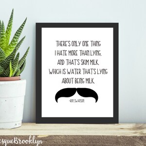 May include: A framed print with a black border featuring a quote about skim milk and a mustache graphic. A potted succulent plant sits to the left. The text reads "THERE'S ONLY ONE THING I HATE MORE THAN LYING, AND THAT'S SKIM MILK..."