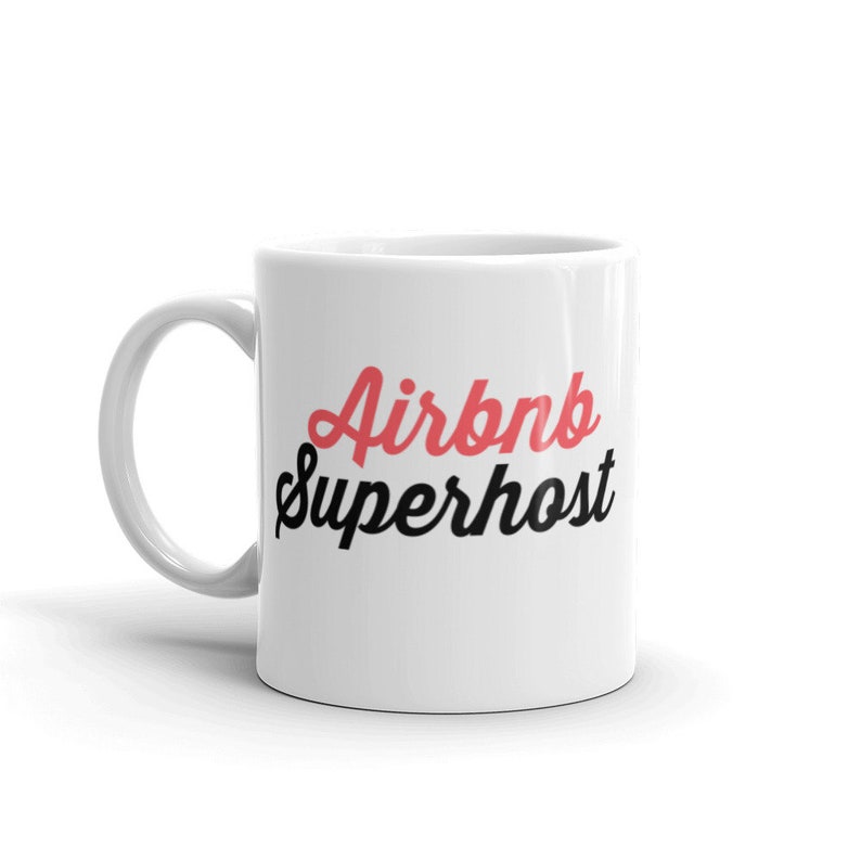 May include: White ceramic mug with the text "Airbnb Superhost" in red and black lettering.