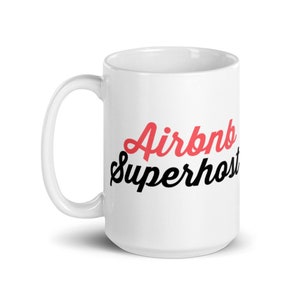 May include: White ceramic mug with a black and red design that says "Airbnb Superhost".
