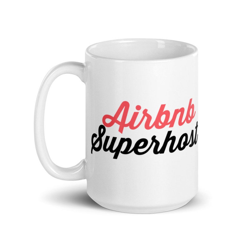 May include: White ceramic mug with a black and red design that says "Airbnb Superhost".