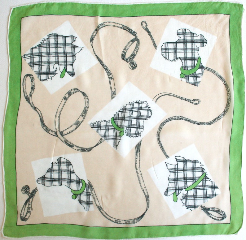 May include: A beige square scarf with a green border features a repeating pattern of black and white plaid dogs with green collars and leashes.
