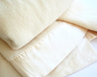 Vintage wool blanket by Kenwood. Off white, cream, satin trim, retro wool blanket