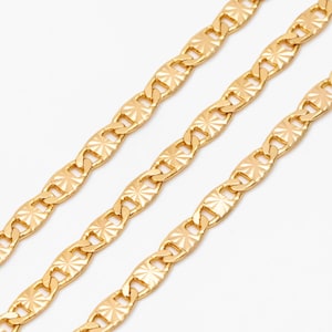 May include: Three gold chains with a diamond-shaped pattern on each link.