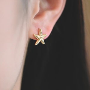 May include: Gold-toned starfish stud earrings. The earrings are small and delicate, and they are perfect for adding a touch of whimsy to any outfit.