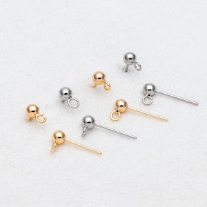 May include: A set of six gold and silver bead caps with loops. The bead caps are used for jewelry making.