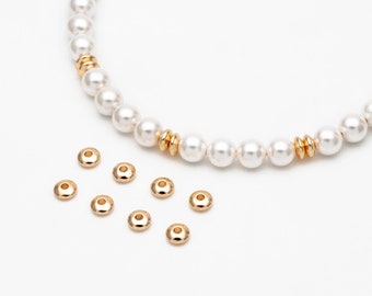 May include: A strand of white pearl beads with gold accents and a scattering of gold bead caps.