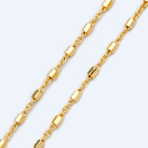 May include: A gold chain necklace with small, rectangular links.