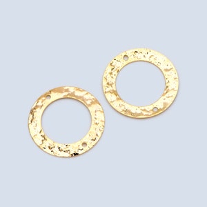 May include: Two gold-toned metal circles with a hammered texture and two holes each. The circles are about 1 inch in diameter.