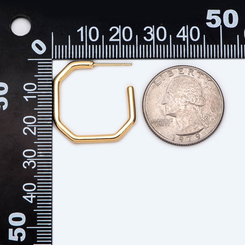 May include: Gold octagon hoop earrings, shown next to a US quarter for size comparison.