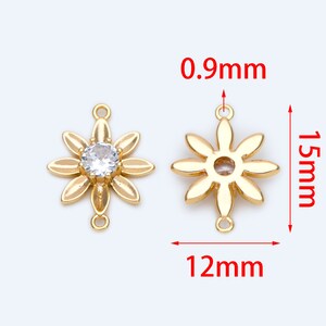 May include: Gold-tone flower-shaped connector with a clear rhinestone in the center. The connector measures 1.5 inches in height and 1.2 inches in width. It has two loops on the top and bottom for attaching to jewelry.