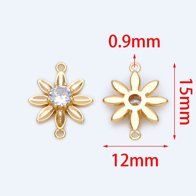 May include: Gold-tone flower-shaped connector with a clear rhinestone in the center. The connector measures 1.5 inches in height and 1.2 inches in width. It has two loops on the top and bottom for attaching to jewelry.