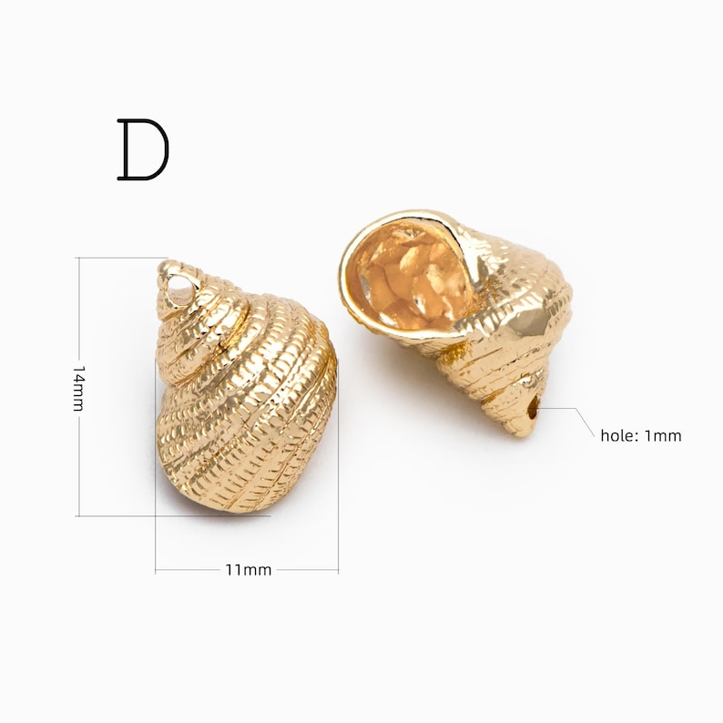 May include: Two gold-colored metal seashell charms labeled D. The left charm measures 14mm by 11mm. The right charm features a visible 1mm hole. Both items have a textured, spiraled surface detail and a metallic finish.
