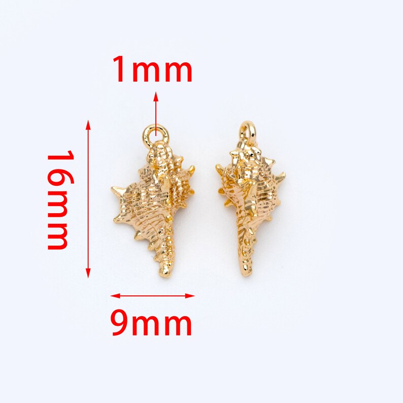 May include: Two gold-colored seashell charms with a loop at the top for attaching to jewelry. The charms are 16 mm tall, 9 mm wide, and 1 mm thick.