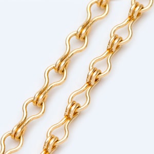 May include: A gold chain necklace with a delicate, linked design. Each link is shaped like a figure eight, creating a unique and elegant look.