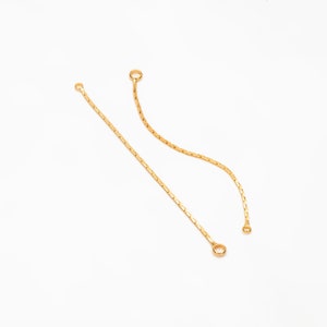 May include: Two gold chain extenders with jump rings at each end.