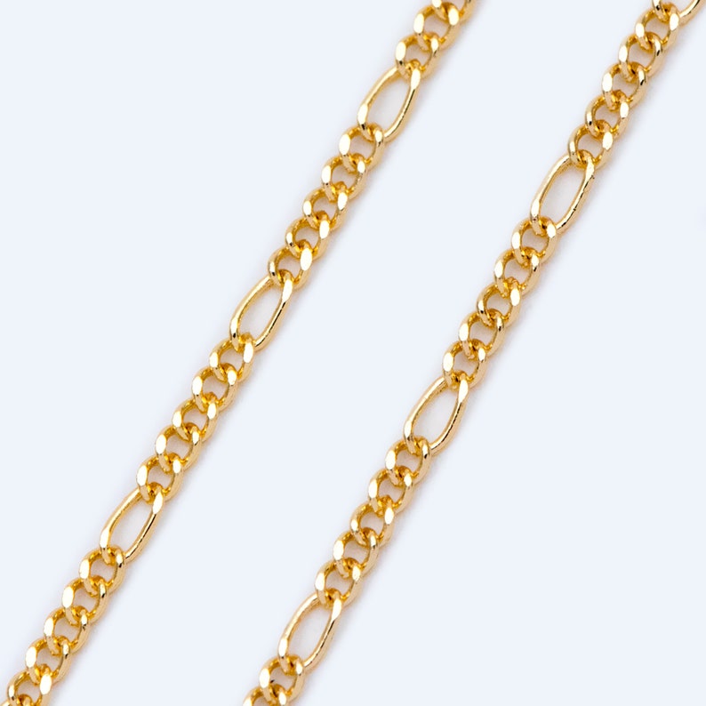 May include: A gold chain necklace with a classic figaro link design. The chain is made of metal and has a polished finish.
