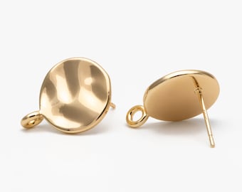 May include: Two gold-colored stud earrings. Each earring features a circular, slightly irregular disc shape with a small loop at the bottom and a post for piercing. The earrings have a shiny, reflective surface.