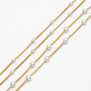 May include: Four gold chains with white pearl accents. The chains are layered on a white background.