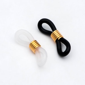 以下が含まれることがあります： 金色の金属製のアクセントが付いた、黒と白の2つの眼鏡チェーンホルダー