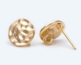 May include: A pair of gold-toned hammered disc earrings. The earrings are round and have a textured surface.