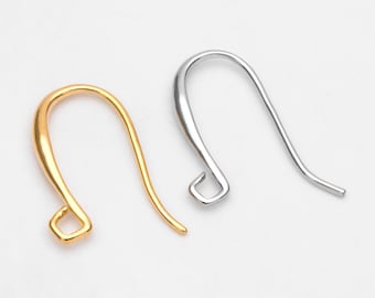 May include: Two earring hooks, one gold-colored and one silver-colored, are displayed against a white background. The hooks have a curved design with a small loop at the bottom for attaching earrings. These are jewelry-making supplies.